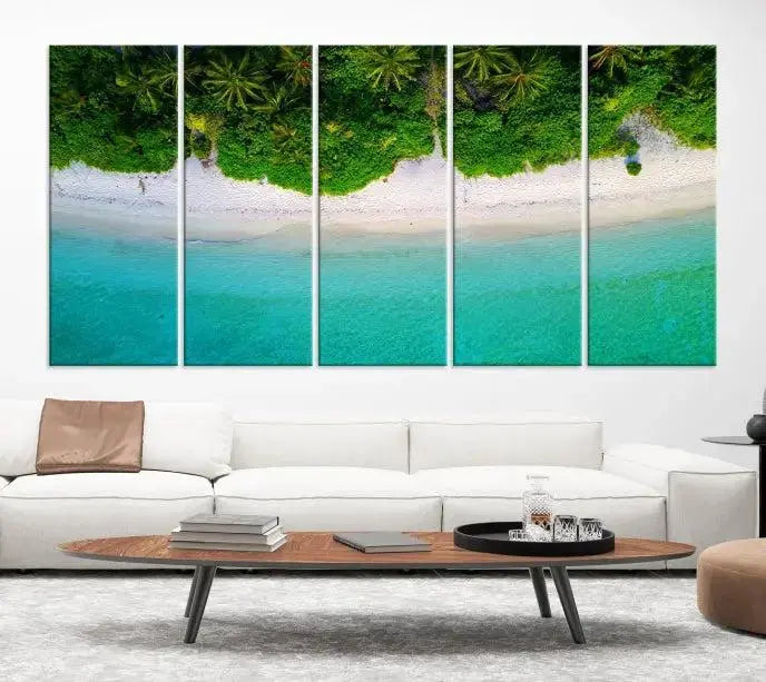 The Forest and Aerial Ocean Wall Art Canvas Print depicts a tropical beach scene, showcasing turquoise waters, white sand, and lush green trees. This triptych is gallery wrapped on museum-quality canvas and features a UV-protective coating to maintain its vibrant colors.