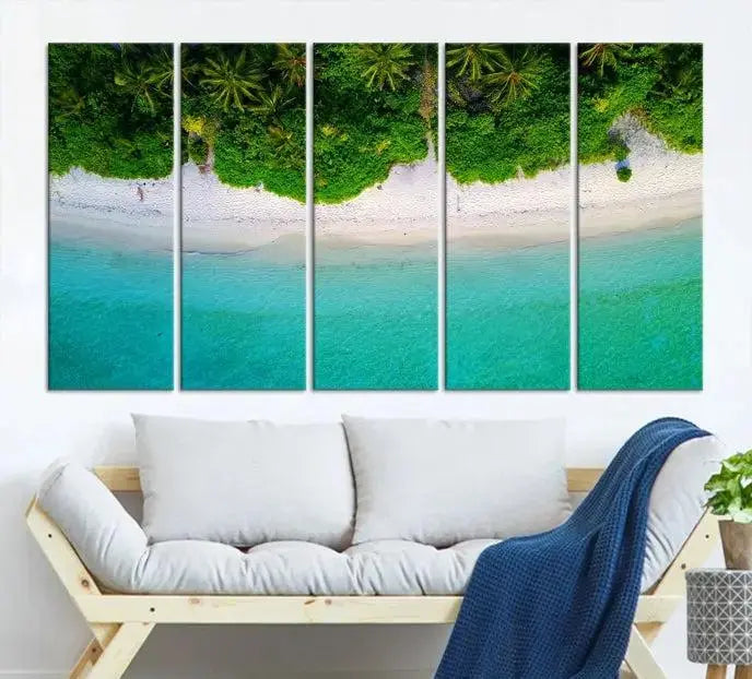 The Forest and Aerial Ocean Wall Art Canvas Print depicts a tropical beach scene, showcasing turquoise waters, white sand, and lush green trees. This triptych is gallery wrapped on museum-quality canvas and features a UV-protective coating to maintain its vibrant colors.