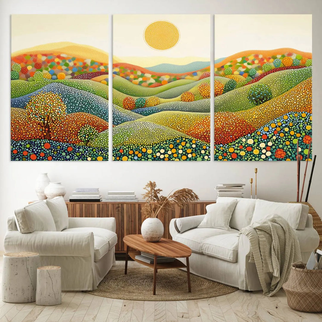 A framed Yayoi Kusama print featuring an abstract pointillism-inspired landscape of vibrant rolling hills and a sun.