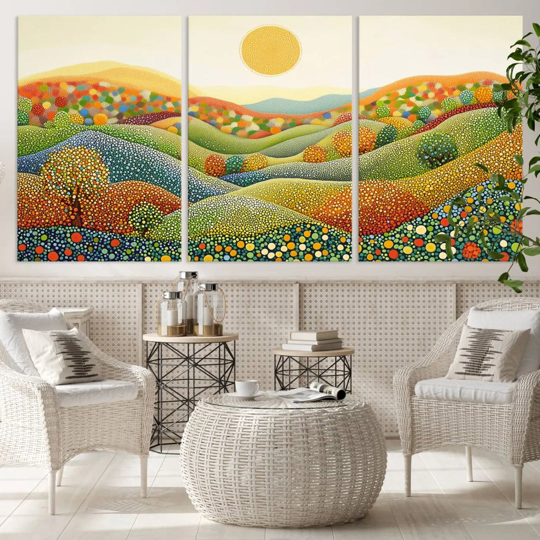 A framed Yayoi Kusama print featuring an abstract pointillism-inspired landscape of vibrant rolling hills and a sun.