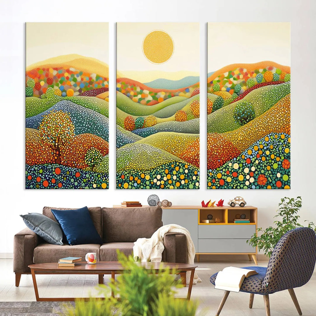 A framed Yayoi Kusama print featuring an abstract pointillism-inspired landscape of vibrant rolling hills and a sun.