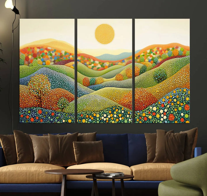 A framed Yayoi Kusama print featuring an abstract pointillism-inspired landscape of vibrant rolling hills and a sun.