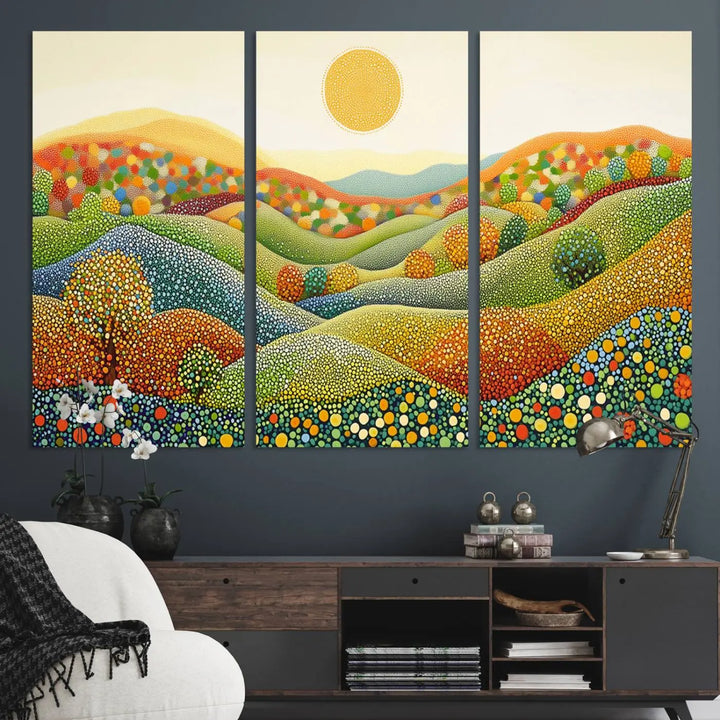 A framed Yayoi Kusama print featuring an abstract pointillism-inspired landscape of vibrant rolling hills and a sun.