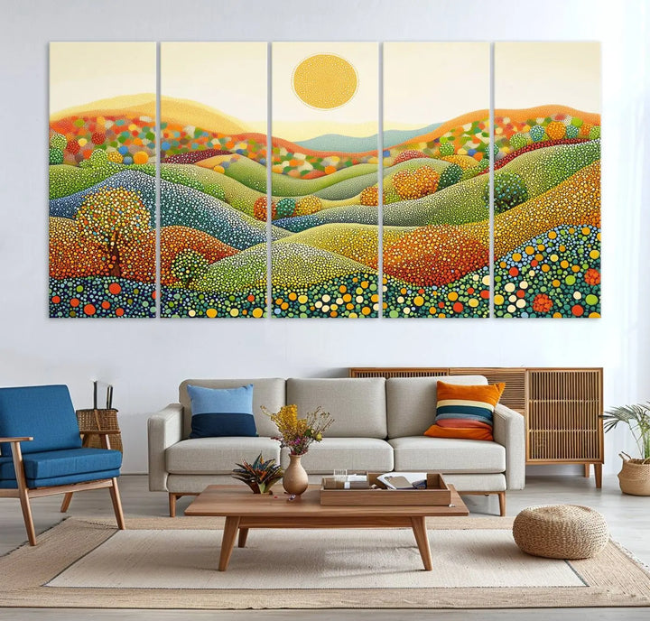 A framed Yayoi Kusama print featuring an abstract pointillism-inspired landscape of vibrant rolling hills and a sun.