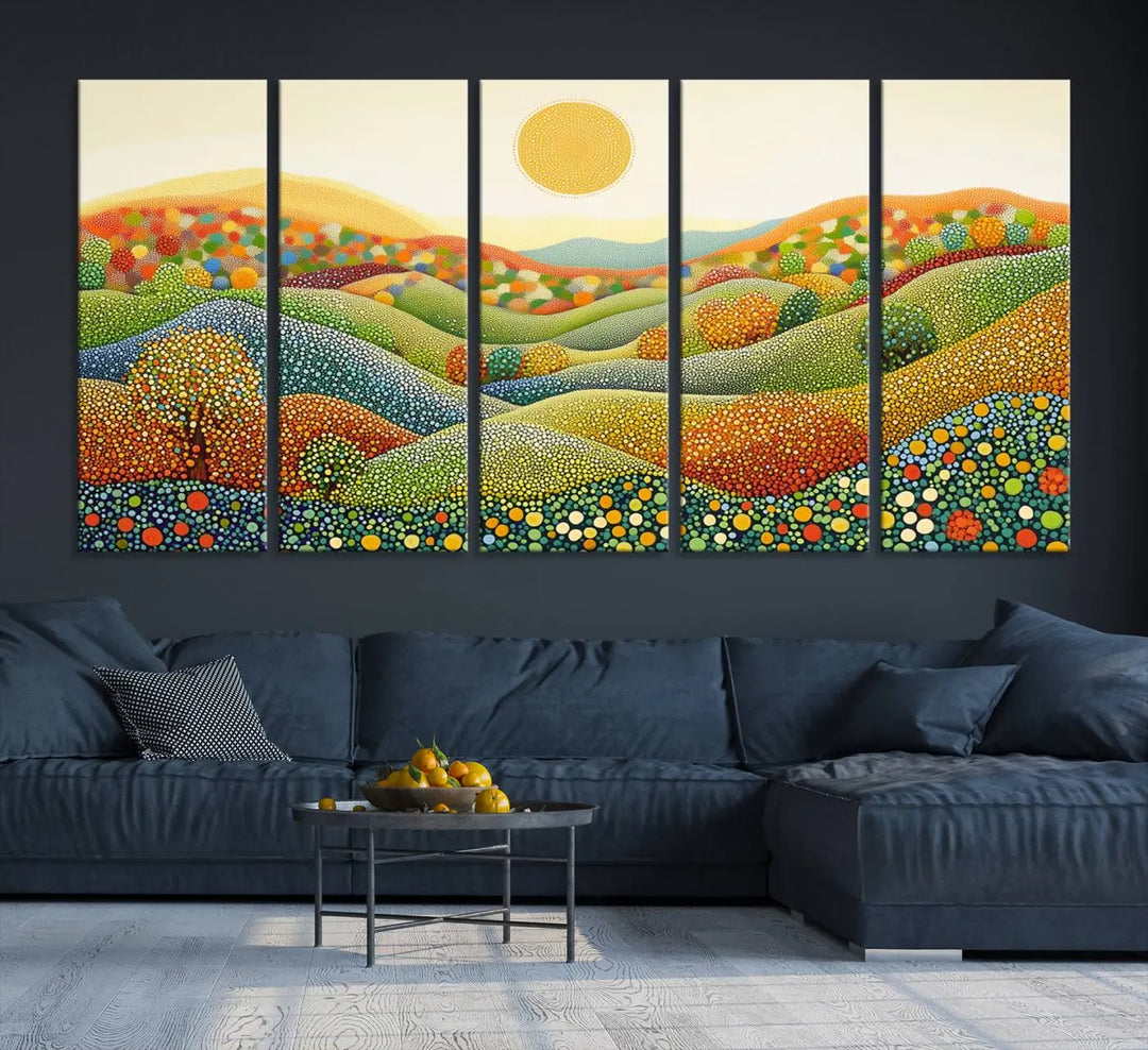 A framed Yayoi Kusama print featuring an abstract pointillism-inspired landscape of vibrant rolling hills and a sun.