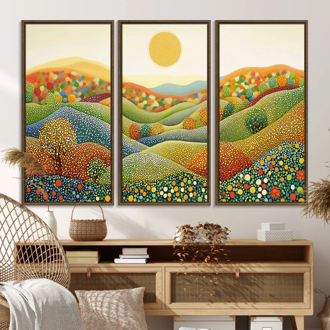 A framed Yayoi Kusama print featuring an abstract pointillism-inspired landscape of vibrant rolling hills and a sun.