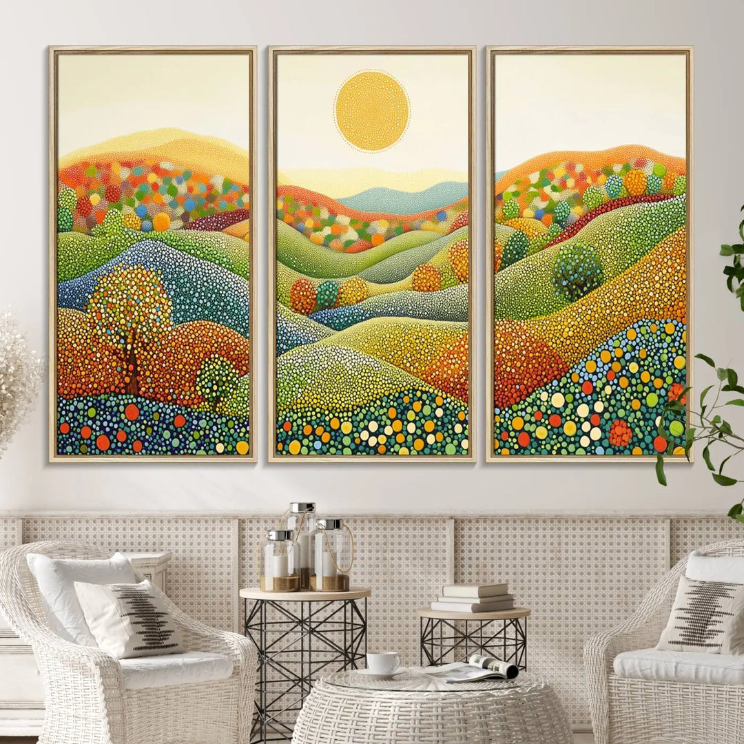 A framed Yayoi Kusama print featuring an abstract pointillism-inspired landscape of vibrant rolling hills and a sun.