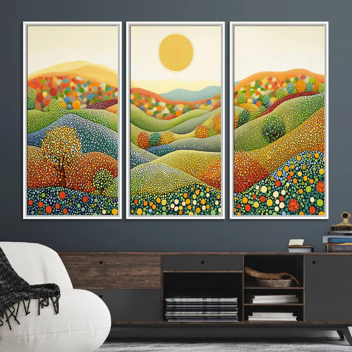 A framed Yayoi Kusama print featuring an abstract pointillism-inspired landscape of vibrant rolling hills and a sun.