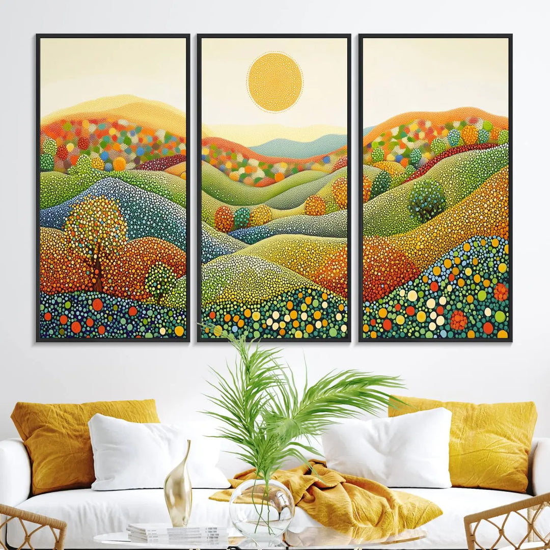 A framed Yayoi Kusama print featuring an abstract pointillism-inspired landscape of vibrant rolling hills and a sun.