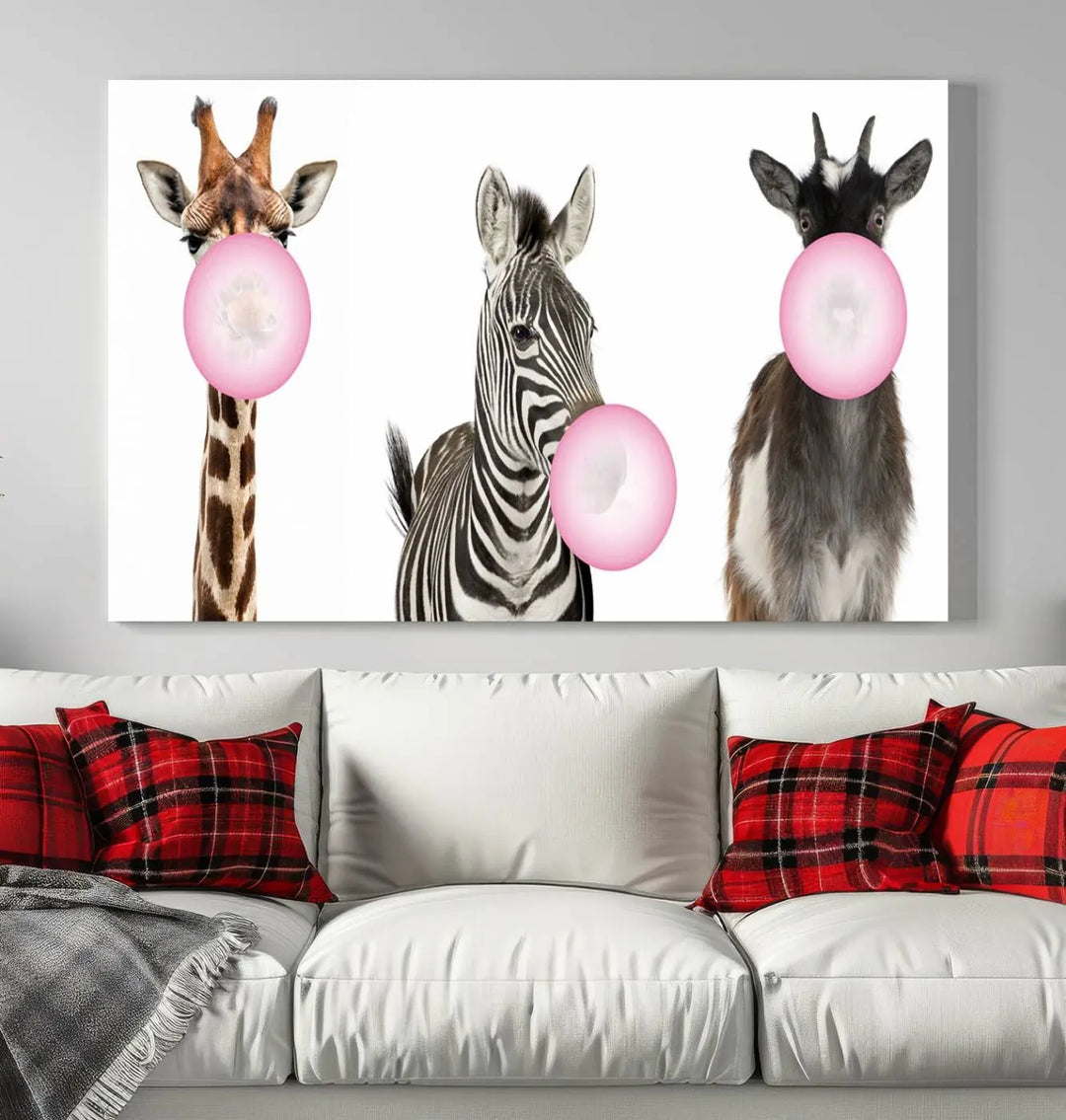 The "Funny Animals Canvas Wall Art Goat Zebra Giraffe Canvas Print" features a giraffe, zebra, and goat blowing pink bubblegum on museum-quality canvas, adding a playful touch to the space.