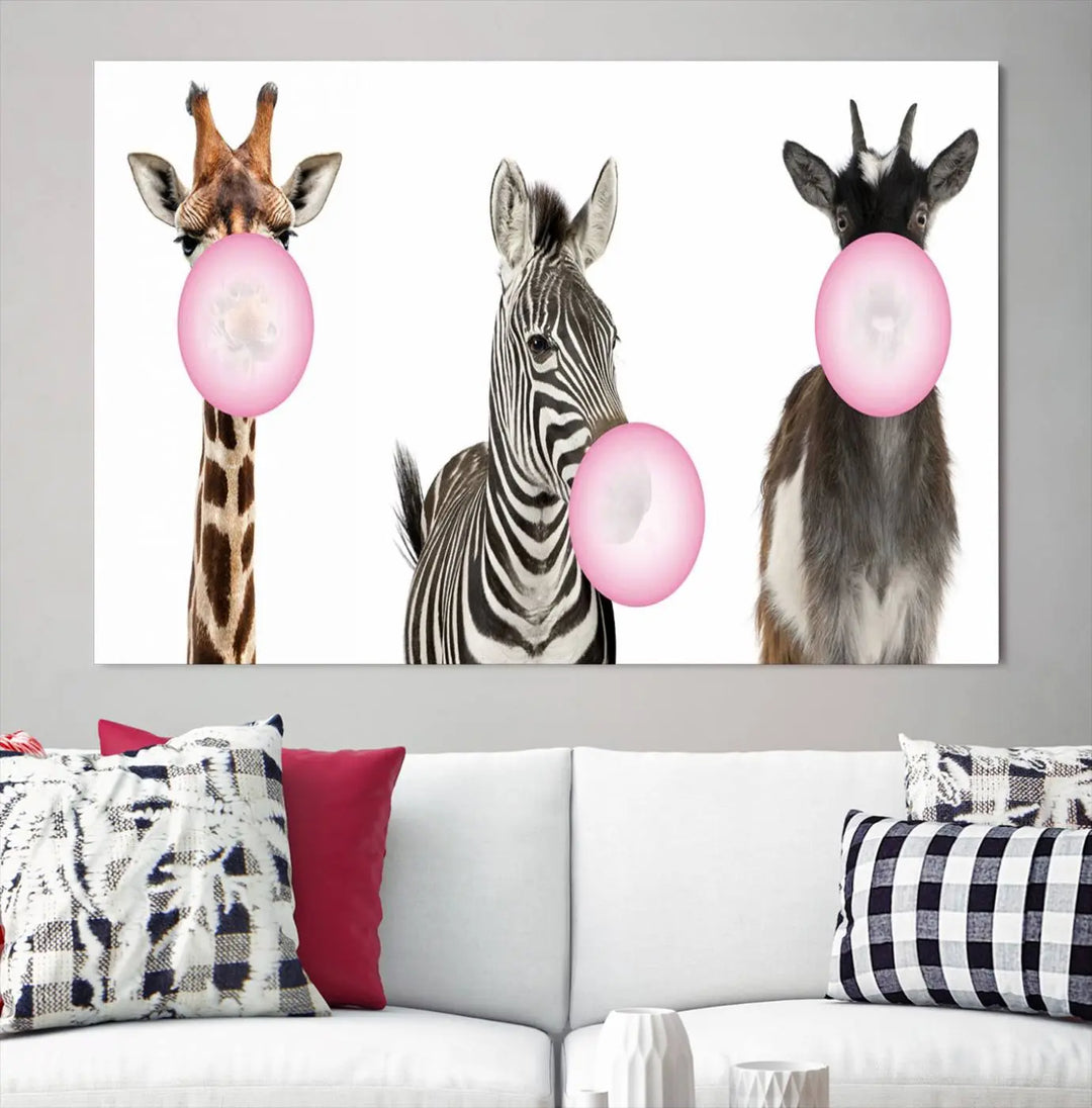 The "Funny Animals Canvas Wall Art Goat Zebra Giraffe Canvas Print" features a giraffe, zebra, and goat blowing pink bubblegum on museum-quality canvas, adding a playful touch to the space.