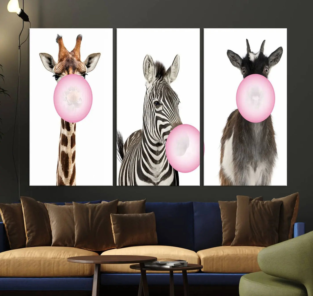 The "Funny Animals Canvas Wall Art Goat Zebra Giraffe Canvas Print" features a giraffe, zebra, and goat blowing pink bubblegum on museum-quality canvas, adding a playful touch to the space.