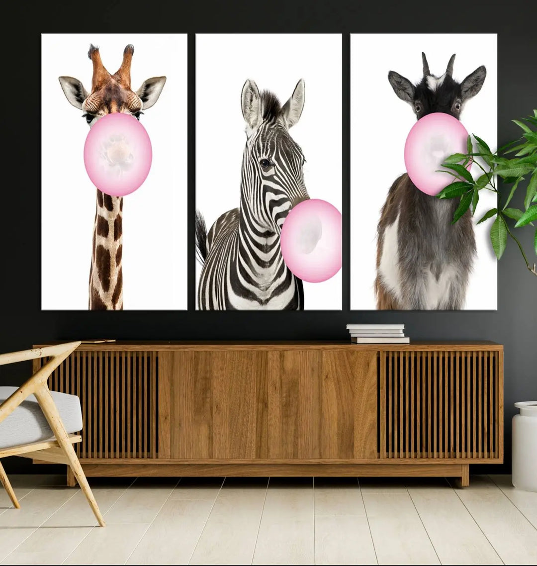 The "Funny Animals Canvas Wall Art Goat Zebra Giraffe Canvas Print" features a giraffe, zebra, and goat blowing pink bubblegum on museum-quality canvas, adding a playful touch to the space.