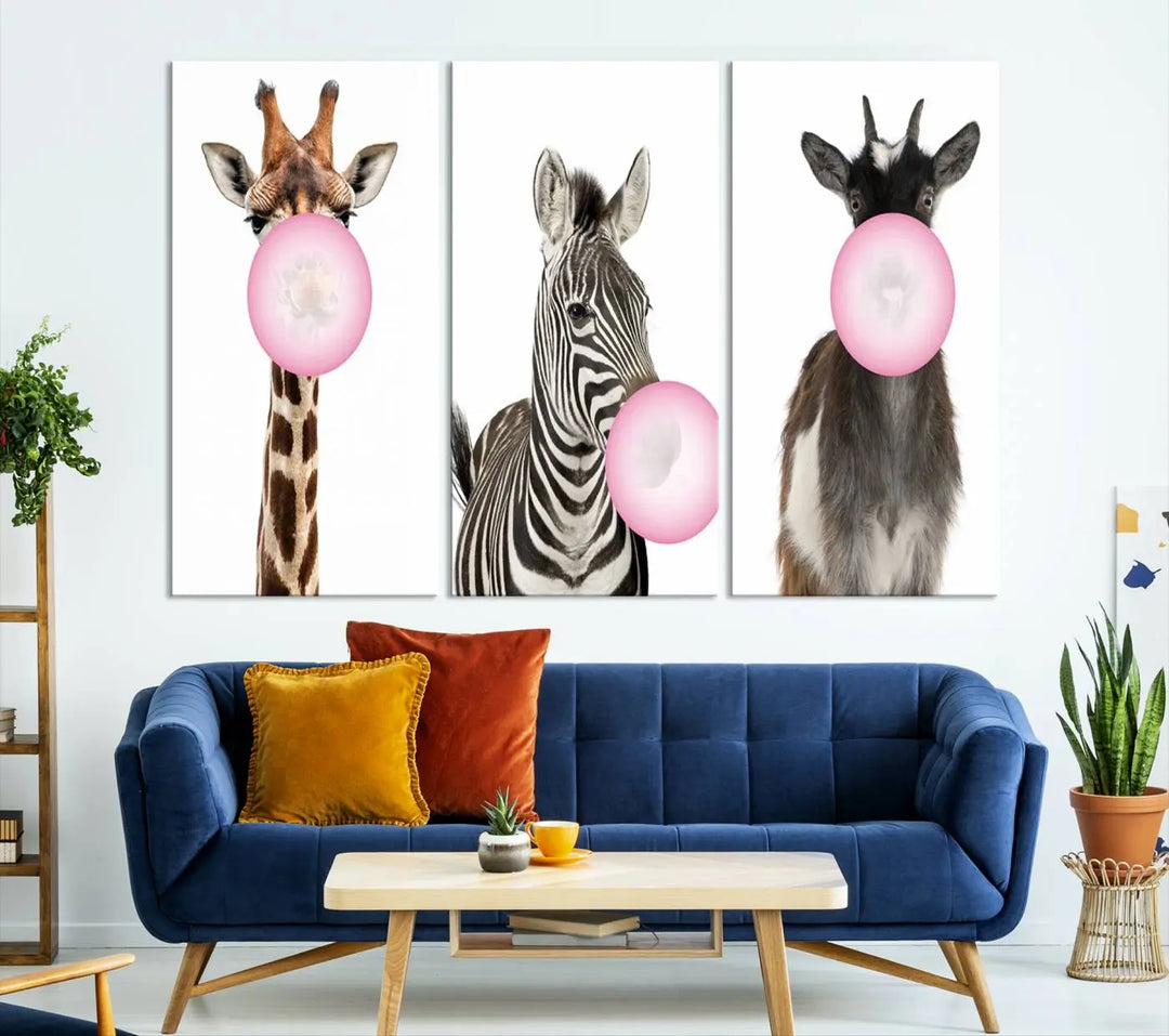 The "Funny Animals Canvas Wall Art Goat Zebra Giraffe Canvas Print" features a giraffe, zebra, and goat blowing pink bubblegum on museum-quality canvas, adding a playful touch to the space.