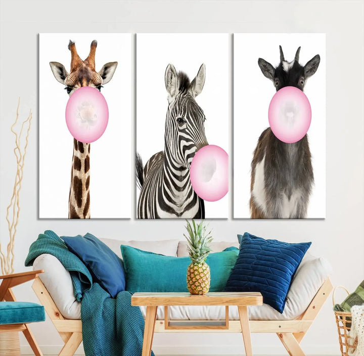 The "Funny Animals Canvas Wall Art Goat Zebra Giraffe Canvas Print" features a giraffe, zebra, and goat blowing pink bubblegum on museum-quality canvas, adding a playful touch to the space.