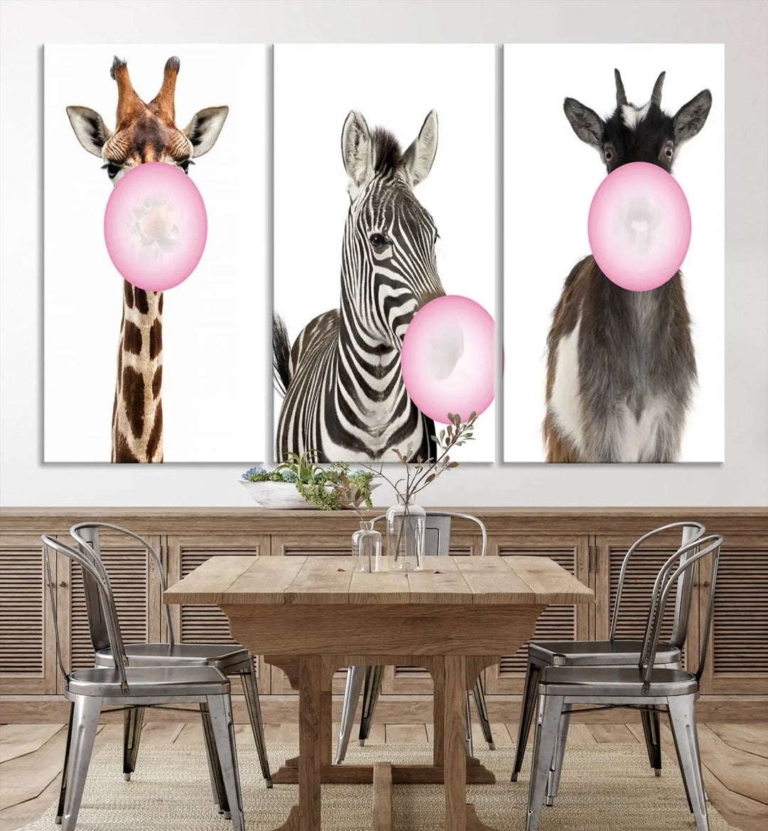 The "Funny Animals Canvas Wall Art Goat Zebra Giraffe Canvas Print" features a giraffe, zebra, and goat blowing pink bubblegum on museum-quality canvas, adding a playful touch to the space.