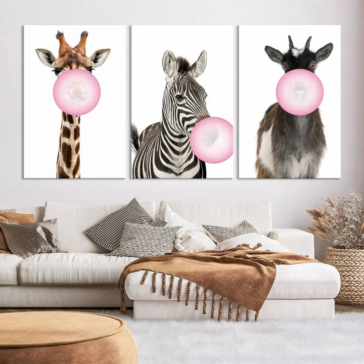 The "Funny Animals Canvas Wall Art Goat Zebra Giraffe Canvas Print" features a giraffe, zebra, and goat blowing pink bubblegum on museum-quality canvas, adding a playful touch to the space.