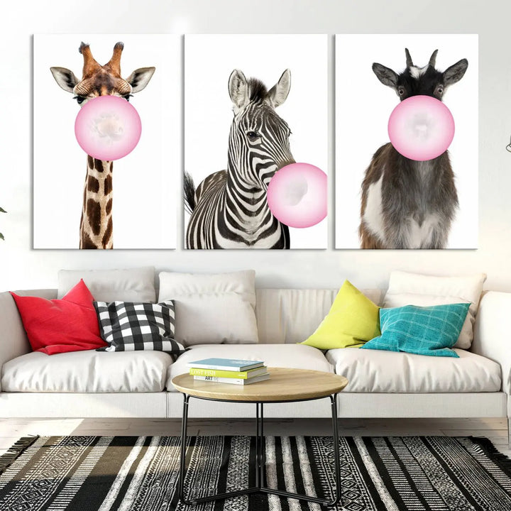 The "Funny Animals Canvas Wall Art Goat Zebra Giraffe Canvas Print" features a giraffe, zebra, and goat blowing pink bubblegum on museum-quality canvas, adding a playful touch to the space.