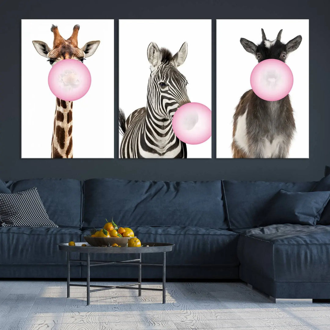 The "Funny Animals Canvas Wall Art Goat Zebra Giraffe Canvas Print" features a giraffe, zebra, and goat blowing pink bubblegum on museum-quality canvas, adding a playful touch to the space.