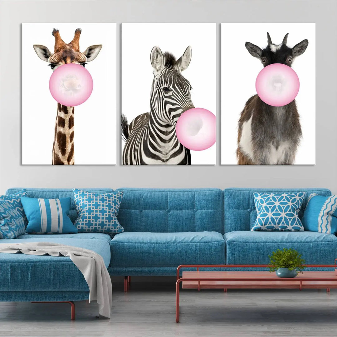 The "Funny Animals Canvas Wall Art Goat Zebra Giraffe Canvas Print" features a giraffe, zebra, and goat blowing pink bubblegum on museum-quality canvas, adding a playful touch to the space.