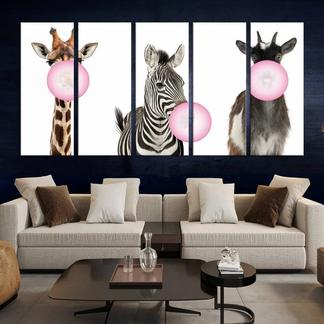 The "Funny Animals Canvas Wall Art Goat Zebra Giraffe Canvas Print" features a giraffe, zebra, and goat blowing pink bubblegum on museum-quality canvas, adding a playful touch to the space.