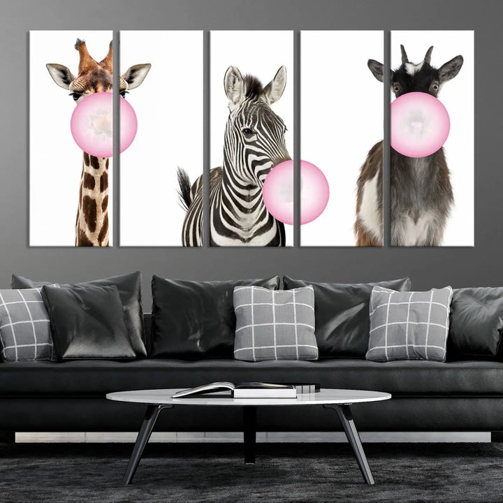 The "Funny Animals Canvas Wall Art Goat Zebra Giraffe Canvas Print" features a giraffe, zebra, and goat blowing pink bubblegum on museum-quality canvas, adding a playful touch to the space.