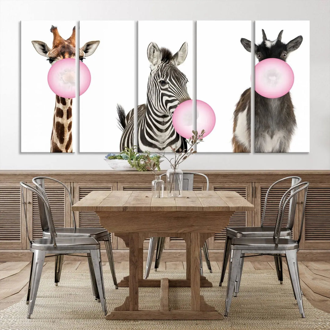 The "Funny Animals Canvas Wall Art Goat Zebra Giraffe Canvas Print" features a giraffe, zebra, and goat blowing pink bubblegum on museum-quality canvas, adding a playful touch to the space.