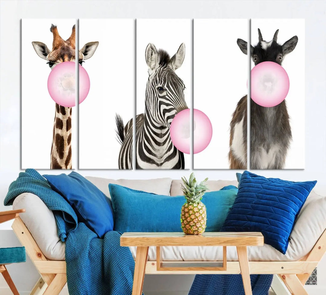 The "Funny Animals Canvas Wall Art Goat Zebra Giraffe Canvas Print" features a giraffe, zebra, and goat blowing pink bubblegum on museum-quality canvas, adding a playful touch to the space.