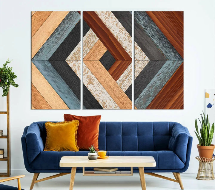 Above the blue sofa hangs the Geometric Wood Art Wall Decor Canvas Print, Rustic Wooden Pattern Triptych Wall Art for Living Room – Ready to Hang. This piece adds rustic charm to the space with its unique wall decor.