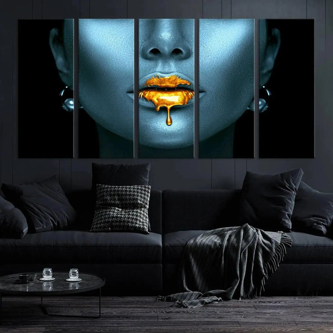 The Glitter Lips Wall Art Gold Lips Canvas Art Print in the contemporary living room showcases a blue-faced figure with glitter lips across three panels. The gallery-wrapped finish on high-quality polycotton canvas enhances the room's elegance.