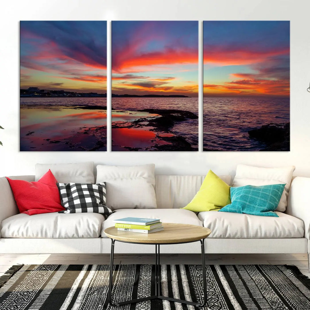 The Glorious Sunset on The Beach Wall Art Canvas Print features a vibrant sunset over rocky shores and is crafted on museum-quality canvas with a UV-protective coating.