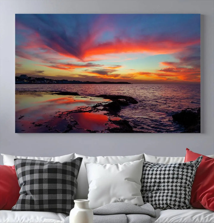 The Glorious Sunset on The Beach Wall Art Canvas Print features a vibrant sunset over rocky shores and is crafted on museum-quality canvas with a UV-protective coating.