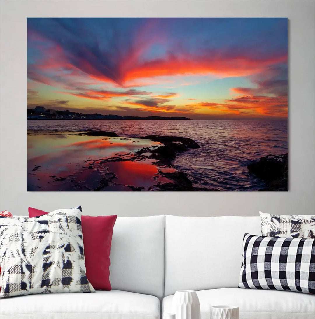 The Glorious Sunset on The Beach Wall Art Canvas Print features a vibrant sunset over rocky shores and is crafted on museum-quality canvas with a UV-protective coating.