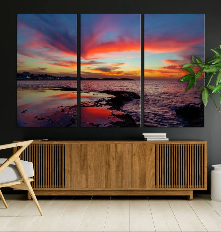 The Glorious Sunset on The Beach Wall Art Canvas Print features a vibrant sunset over rocky shores and is crafted on museum-quality canvas with a UV-protective coating.