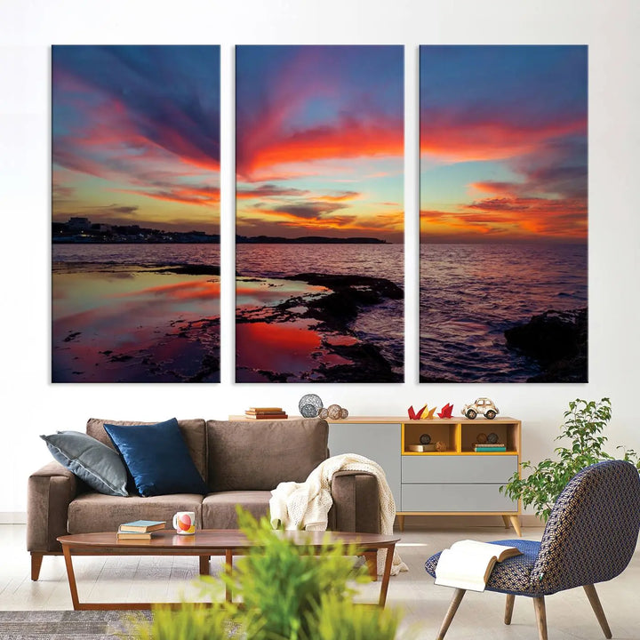 The Glorious Sunset on The Beach Wall Art Canvas Print features a vibrant sunset over rocky shores and is crafted on museum-quality canvas with a UV-protective coating.