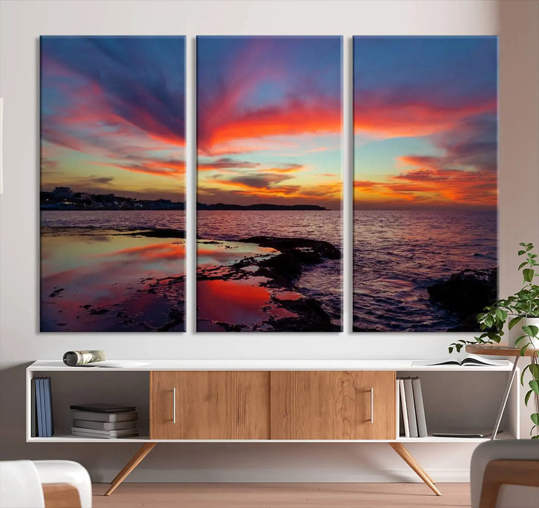 The Glorious Sunset on The Beach Wall Art Canvas Print features a vibrant sunset over rocky shores and is crafted on museum-quality canvas with a UV-protective coating.