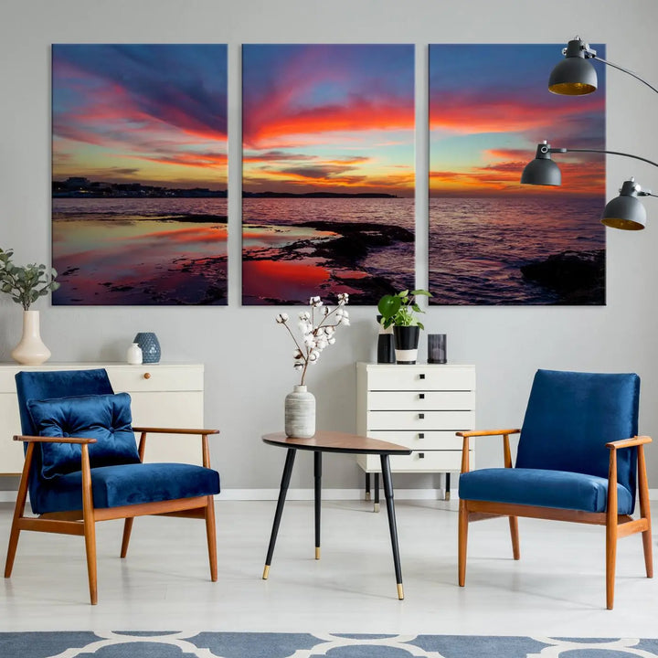 The Glorious Sunset on The Beach Wall Art Canvas Print features a vibrant sunset over rocky shores and is crafted on museum-quality canvas with a UV-protective coating.