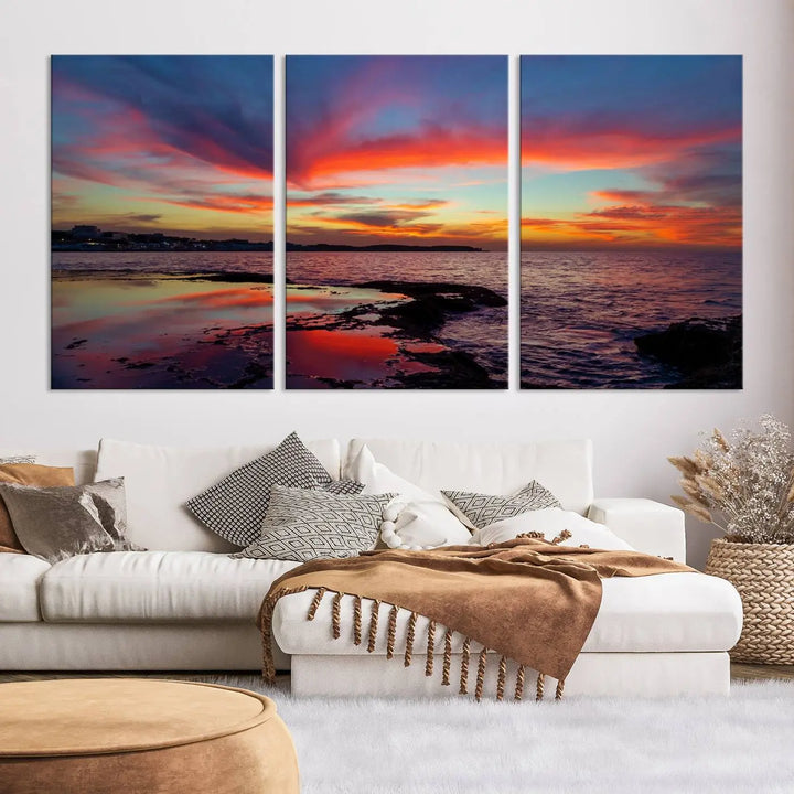 The Glorious Sunset on The Beach Wall Art Canvas Print features a vibrant sunset over rocky shores and is crafted on museum-quality canvas with a UV-protective coating.