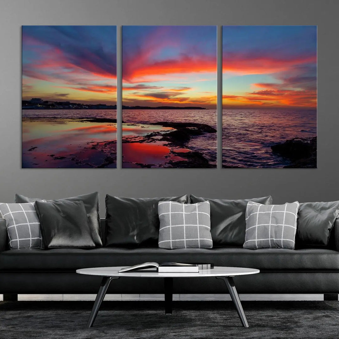 The Glorious Sunset on The Beach Wall Art Canvas Print features a vibrant sunset over rocky shores and is crafted on museum-quality canvas with a UV-protective coating.