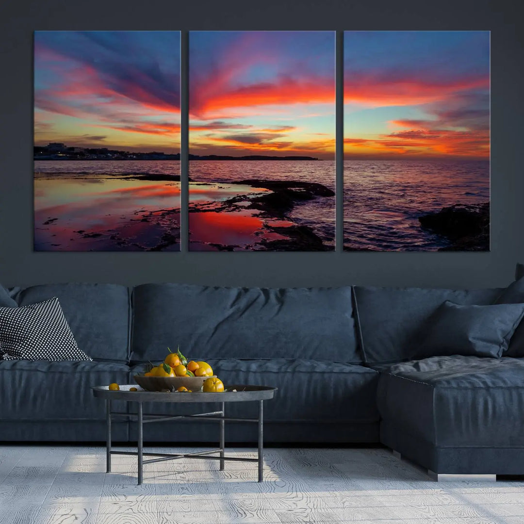 The Glorious Sunset on The Beach Wall Art Canvas Print features a vibrant sunset over rocky shores and is crafted on museum-quality canvas with a UV-protective coating.