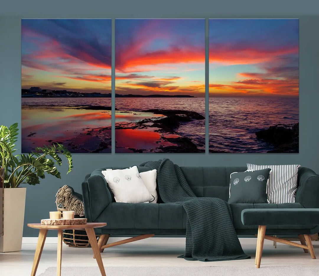 The Glorious Sunset on The Beach Wall Art Canvas Print features a vibrant sunset over rocky shores and is crafted on museum-quality canvas with a UV-protective coating.