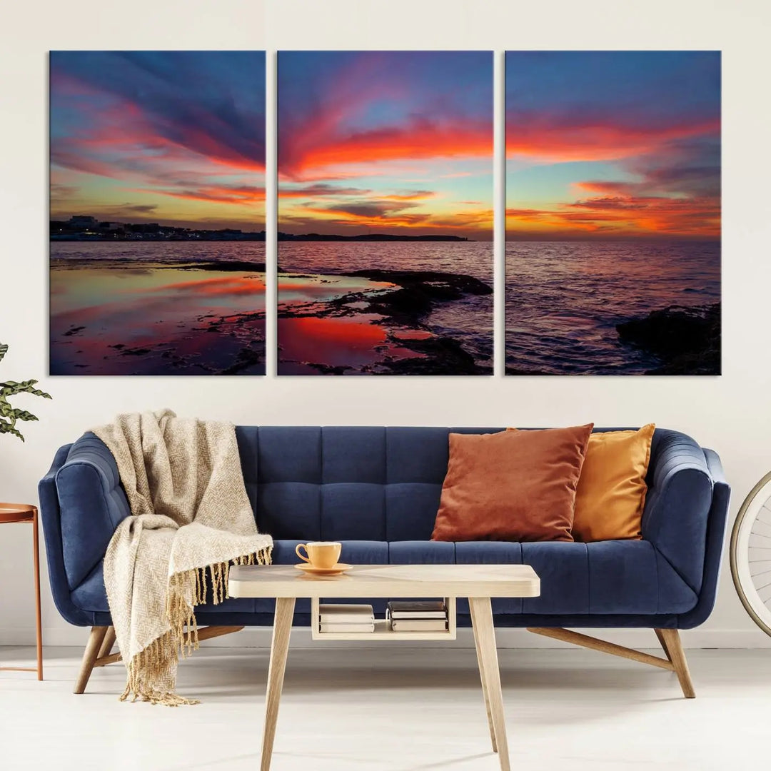 The Glorious Sunset on The Beach Wall Art Canvas Print features a vibrant sunset over rocky shores and is crafted on museum-quality canvas with a UV-protective coating.