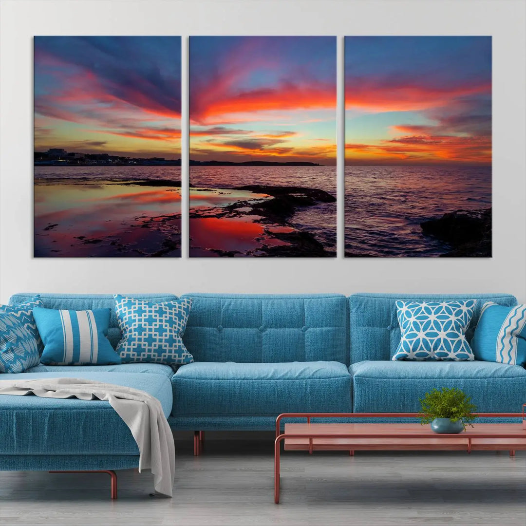 The Glorious Sunset on The Beach Wall Art Canvas Print features a vibrant sunset over rocky shores and is crafted on museum-quality canvas with a UV-protective coating.