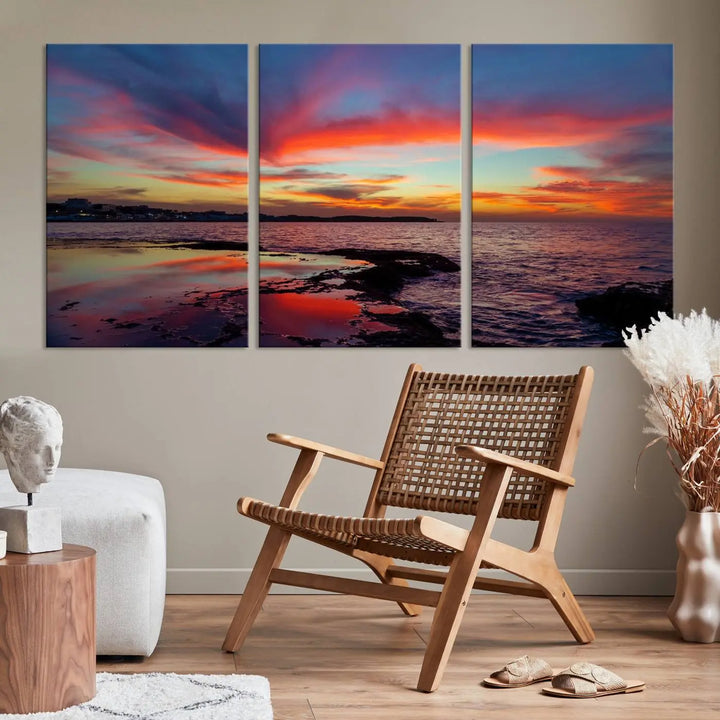 The Glorious Sunset on The Beach Wall Art Canvas Print features a vibrant sunset over rocky shores and is crafted on museum-quality canvas with a UV-protective coating.