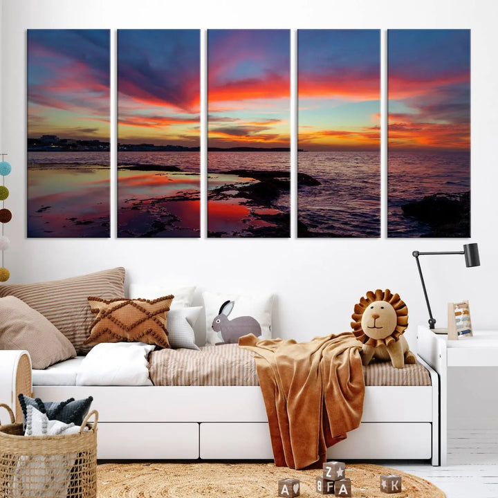 The Glorious Sunset on The Beach Wall Art Canvas Print features a vibrant sunset over rocky shores and is crafted on museum-quality canvas with a UV-protective coating.