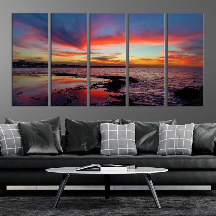 The Glorious Sunset on The Beach Wall Art Canvas Print features a vibrant sunset over rocky shores and is crafted on museum-quality canvas with a UV-protective coating.