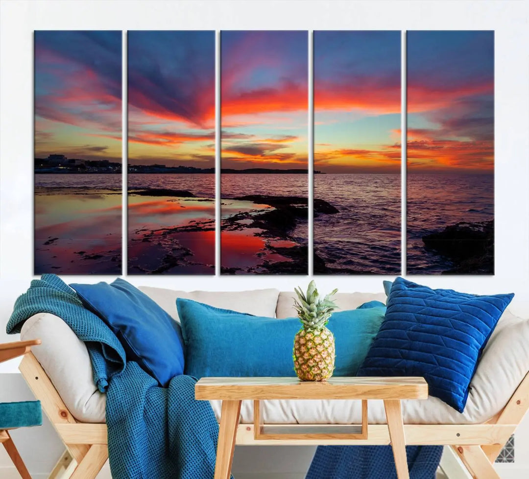 The Glorious Sunset on The Beach Wall Art Canvas Print features a vibrant sunset over rocky shores and is crafted on museum-quality canvas with a UV-protective coating.