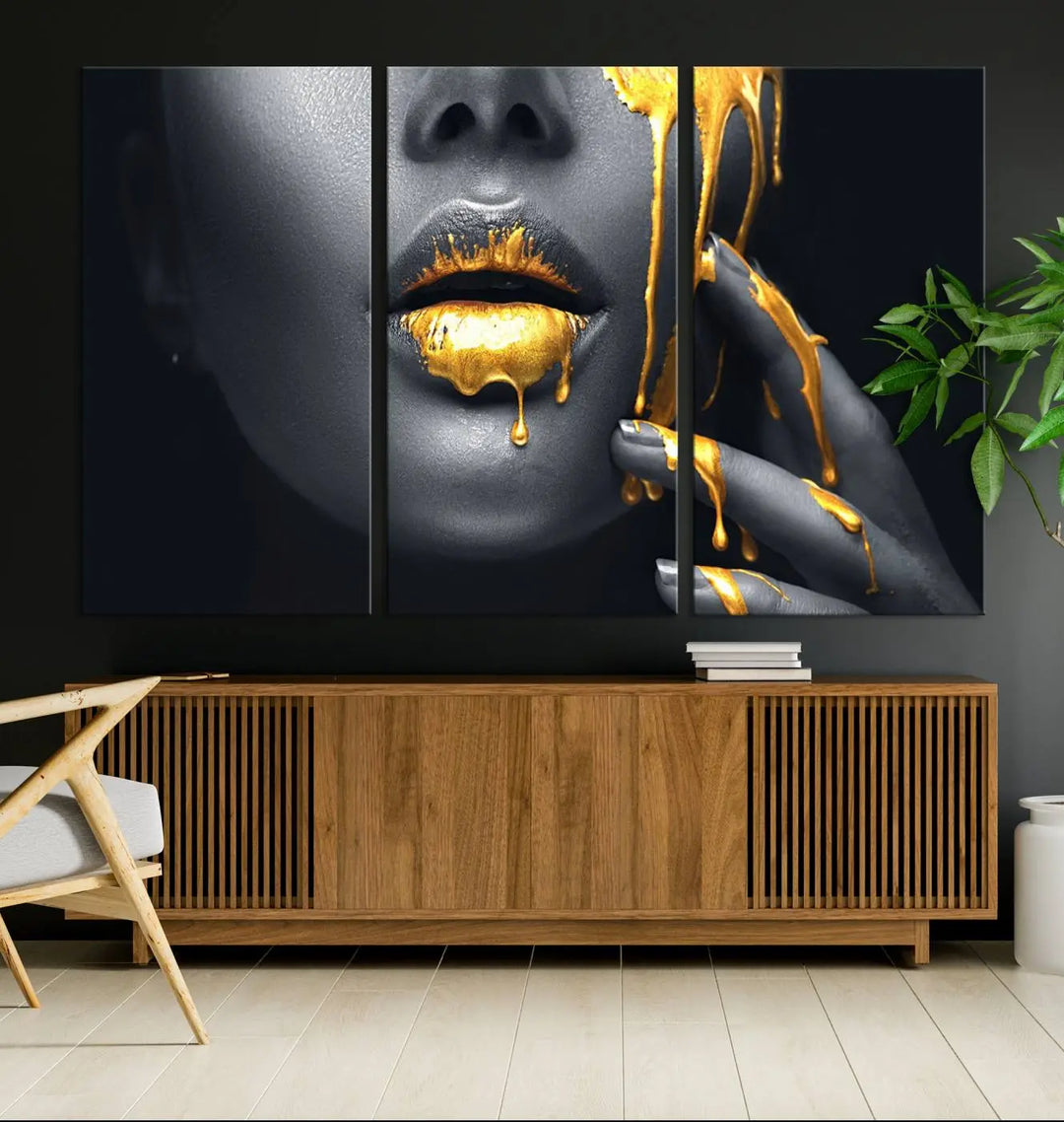 The modern living room features a striking triptych called the "Gold Glitter Lips Fashion Photography Wall Art Makeup" canvas print.