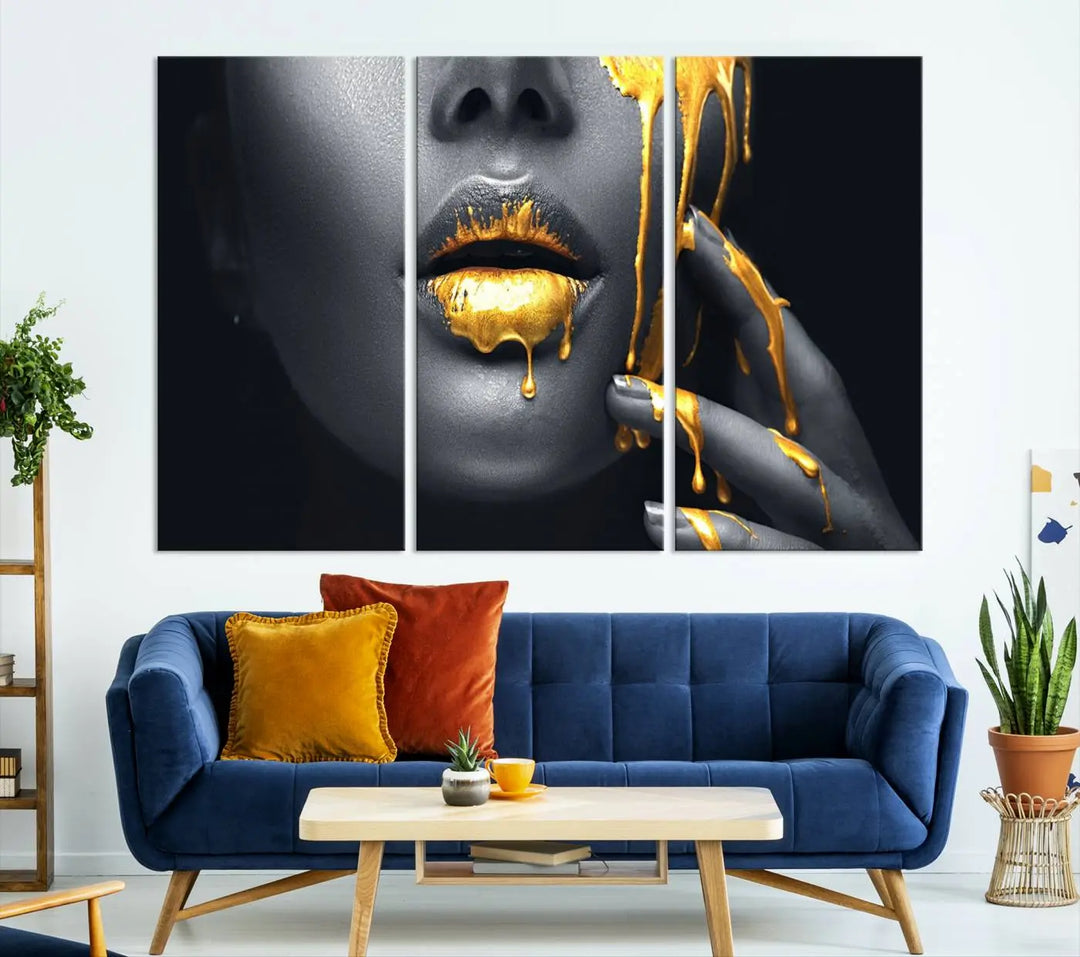 The modern living room features a striking triptych called the "Gold Glitter Lips Fashion Photography Wall Art Makeup" canvas print.