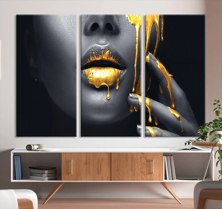 The modern living room features a striking triptych called the "Gold Glitter Lips Fashion Photography Wall Art Makeup" canvas print.